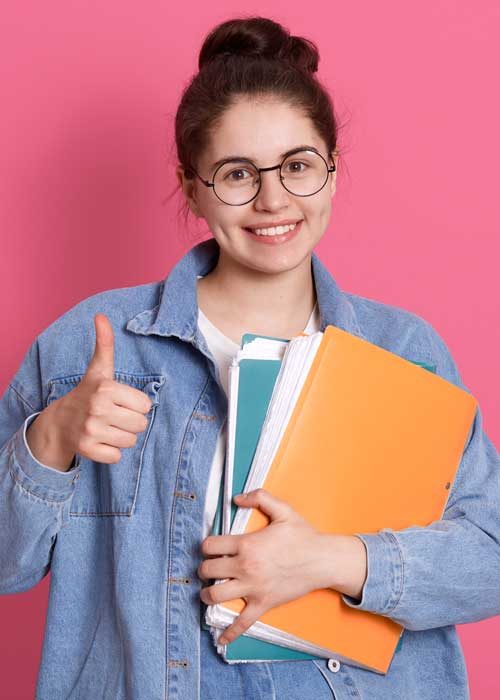 young-student-woman-wearing-denim-jacket-eyeglasses-holding-colorful-folders-showing-thumb-up-pink young-student-woman-wearing-denim-jacket-eyeglasses-holding-colorful-folders-showing-thumb-up-pink